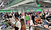 Crowded Olive Young store in central Seoul with shoppers browsing cosmetics and personal care products.