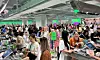 Crowded Olive Young store in central Seoul with shoppers browsing cosmetics and personal care products.