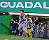 South Korea players in patterned team jackets enter a soccer stadium tunnel under a large Guadalajara sign.