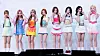 A line of performers in colorful outfits standing on a stage.