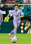 Lee Kang-in in a purple South Korea kit runs with the ball during a match against Mexico.