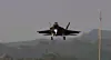 KF-21 Boramae fighter jet flying low over a hazy landscape during a test flight.