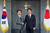 Korean Defense Minister Ahn Gyu-back, left, and Japanese Defense Minister Shinjiro Koizumi shakes their hands in Yongsan District, central Seoul, on June 28.