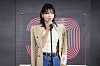 Kim You-jung speaks into a microphone on an outdoor stage at the Busan International Film Festival.
