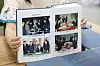 Hands hold open a large book showing four photos from inter-Korean nuclear talks.