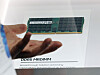 A Samsung DDR5 MRDIMM memory module is shown on a display board at a trade fair.