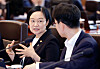 Incoming Prime Minister Han Seong-sook, left, talks with a government official during a Cabinet meeting held on June 30.