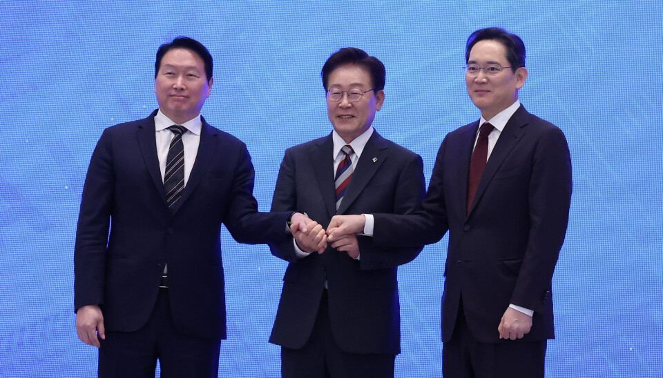 From left, SK Group Chairman Chey Tae-won, President Lee Jae Myung, and Samsung Electronics Executive Chairman Lee Jae-yong join hands after $520 billion investments for four new chip plants at the Blue House in Jongno District, central Seoul, on June 29.