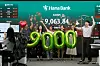 Currency traders celebrate in front of a screen showing the Kospi of over 9,000 points at the trading room of the Hana Bank headquarters in central Seoul on June 18.