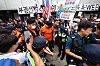 Officers from fire and police authorities control the site where protesters clashed in southern Seoul on July 2 regarding on-site probe of ballot shortages.