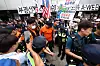 Officers from fire and police authorities control the site where protesters clashed in southern Seoul on July 2 regarding on-site probe of ballot shortages.