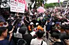 Paramedics respond after a protester fell ill during a demonstration in front of a vote-counting center in southern Seoul on July 2.