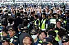 Lawmakers stand and watch police officers' management to clear their path toward a vote-counting center in southern Seoul on July 2.