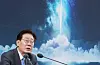 South Korean President Lee Jae-myung speaks at a podium with a space-themed backdrop.