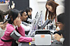 People at a booth in Seoul try blood pressure testing devices at a medical equipment exhibition.
