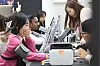 People at a booth in Seoul try blood pressure testing devices at a medical equipment exhibition.
