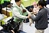 Male visitors try baby products at an exposition held in Gyeonggi on Feb. 26.