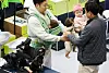 Male visitors try baby products at an exposition held in Gyeonggi on Feb. 26.