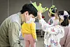 A girl plays with her father at a community center in central Seoul in March 2023.