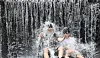Two people cool off in the waters in a valley in North Gyeongsang on July 11.