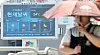 A person uses an umbrella to protect themselves from heat in downtown Seoul on July 12.