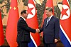 North Korean Premier Pak Thae-song, left, shakes hands with Chinese President Xi Jinping in Beijing, China, on July 11, in a photo carried by Rodong Sinmun.