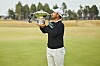 Tom Kim holds a trophy after winning Genesis Scottish Open held in Scotland on July 12.