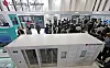 Visitors at LG Energy Solution's booth take a look at its energy storage system products during an exhibition held in southern Seoul on March 6 in 2024.