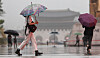 People walk in Gwanghwamun Square in central Seoul on July 8.