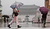 People walk in Gwanghwamun Square in central Seoul on July 8.
