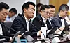 Officials sit at a conference table during a meeting in Seoul City Hall.