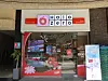 Halo Zero storefront with glass entrance, red signage, and promotional display boards outside.