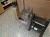 Metal shopping carts beside shelving on a patterned floor in a store interior.