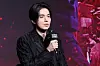 Lee Dong-wook speaking into a microphone at a Disney+ series production event.