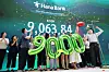 Bankers celebrate Kospi's crossing of 9,000 threshold at Hana Bank's trading room in central Seoul on June 18.
