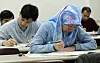 Foreigners solve exam questions in the Test of Proficiency in Korean (Topik) in an undated file photo.