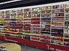 A store wall filled with colorful instant ramen packages arranged on red shelves.