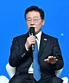 South Korean President Lee Jae-myung speaks into a microphone at the San Francisco AI Summit.