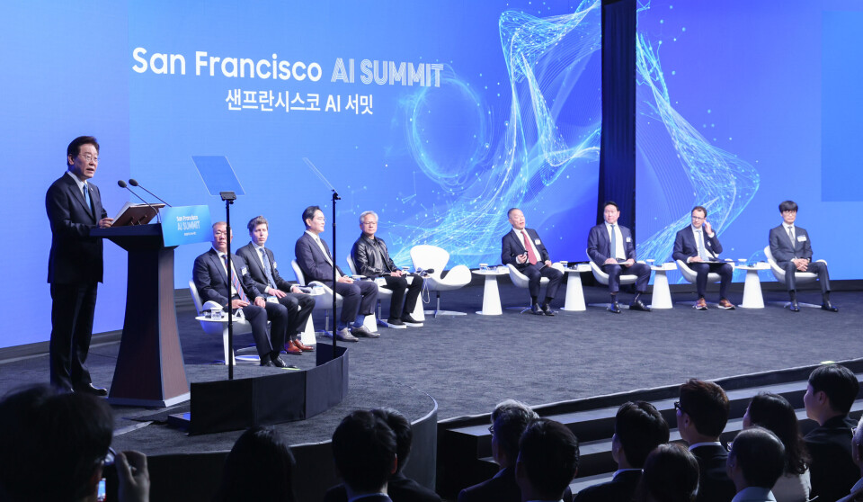 South Korean President Lee Jae-myung speaks at a San Francisco AI summit as panelists sit onstage behind him.
