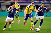 Japanese footballers Keito Nakamura, left, and Daizen Maeda, far right, battle for the ball during the World Cup Group F soccer match in Arlington, Texas, near Dallas, on June 25.