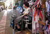 A merchant takes a rest with a hand fan and a mechanic fan at a traditional market in South Gyeongsang on July 27.