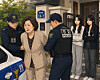 A generative AI-created image depicts a scene where stepmother is arrested by police officers in front of two female siblings.