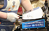 A merchant inserts a credit card into a payment machine at a local market in Mapo District, western Seoul, on July 27, 2023.