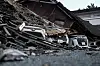 Cars sit crushed beneath debris from a collapsed building after an earthquake with a magnitude of 7.1 struck Kumamoto prefecture, Japan, on July 29.