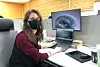 Marina Neretina poses for a photo at her desk at the CnerG office.