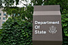 U.S. State Department sign beside greenery outside the Washington, D.C. headquarters.