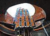 Cylindrical tower with orange panels beneath a large circular skylight at The Sanmaroo Playground.