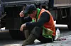 A worker sits down on a road during outdoor work at the Sejong Government Complex on Aug. 4.