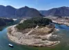 Aerial view of Cheongryeongpo peninsula with tourists walking near the river in Yeongwol, South Korea.