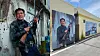 Colorful murals of a man with a rifle painted on a wall beside a narrow sunlit alley.